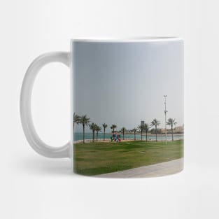 Blue ocean with palm and green grass Mug